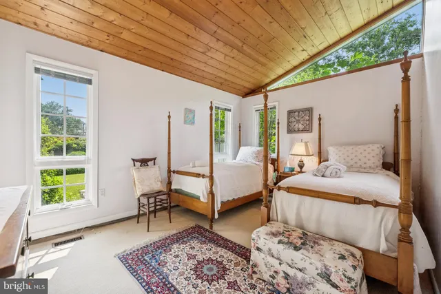 a front view of a house with a yard and potted plants