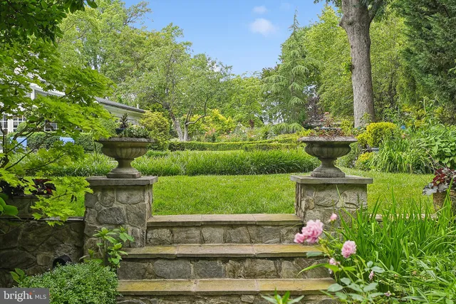 a view of backyard with swimming pool and green space