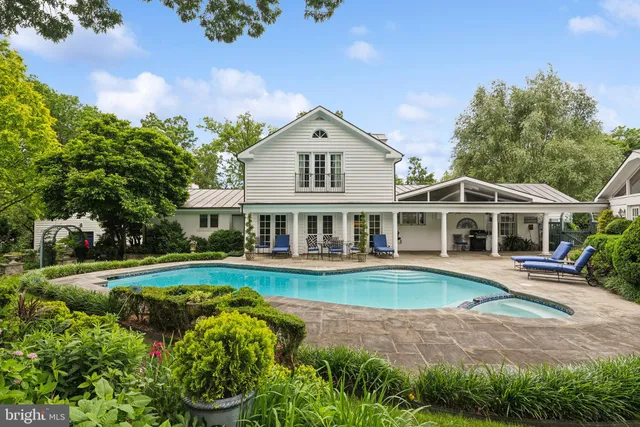front view of a house with a big yard and potted plants