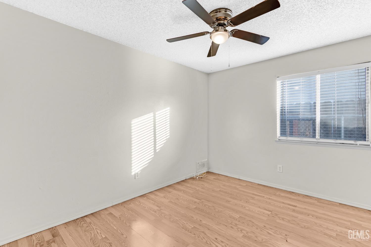 Undisclosed Address Bakersfield, CA 93313 - Photo 18 of 33 an empty room with windows and fan