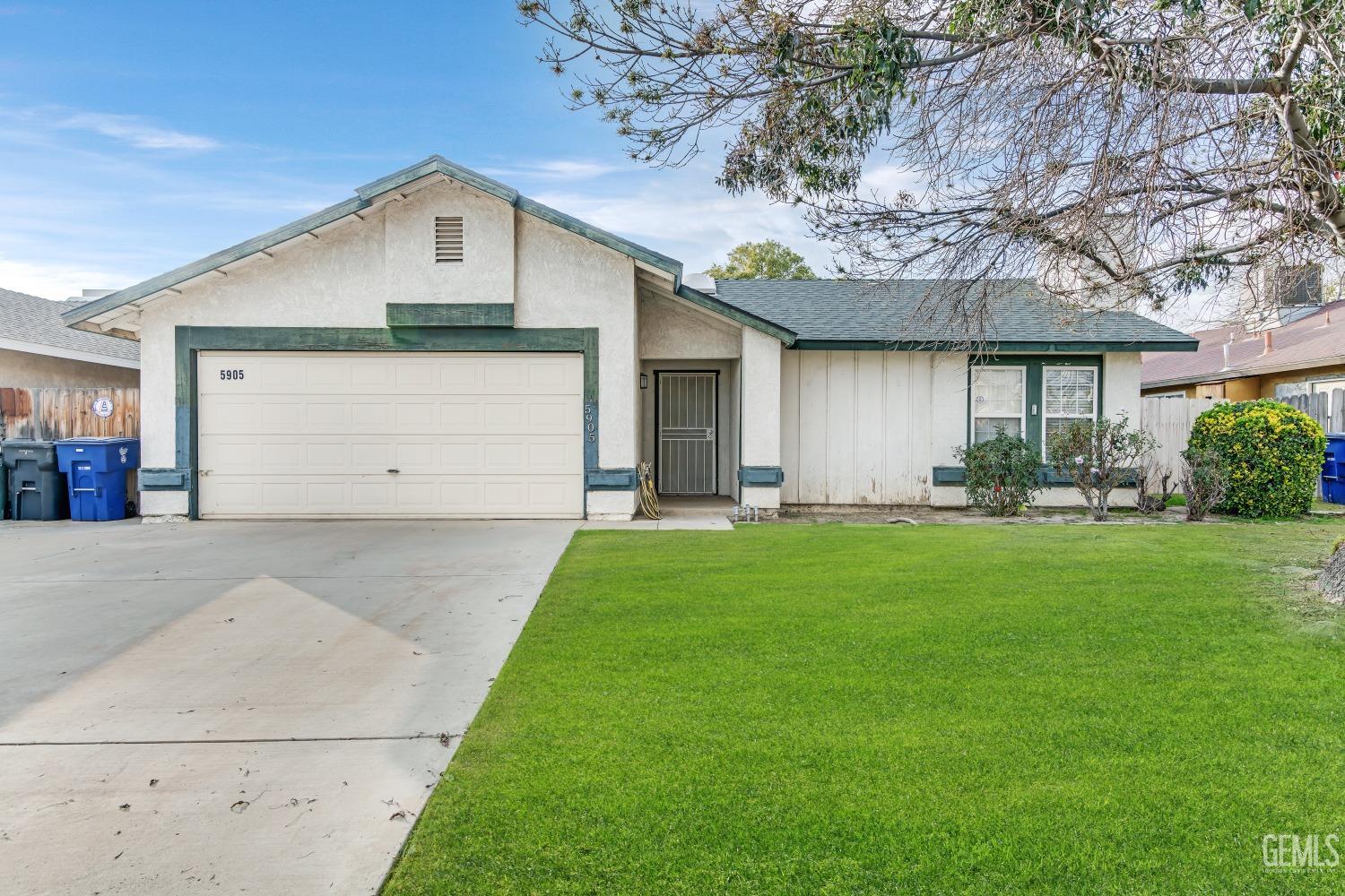 Undisclosed Address Bakersfield, CA 93313 - Photo 2 of 33 a front view of house with yard