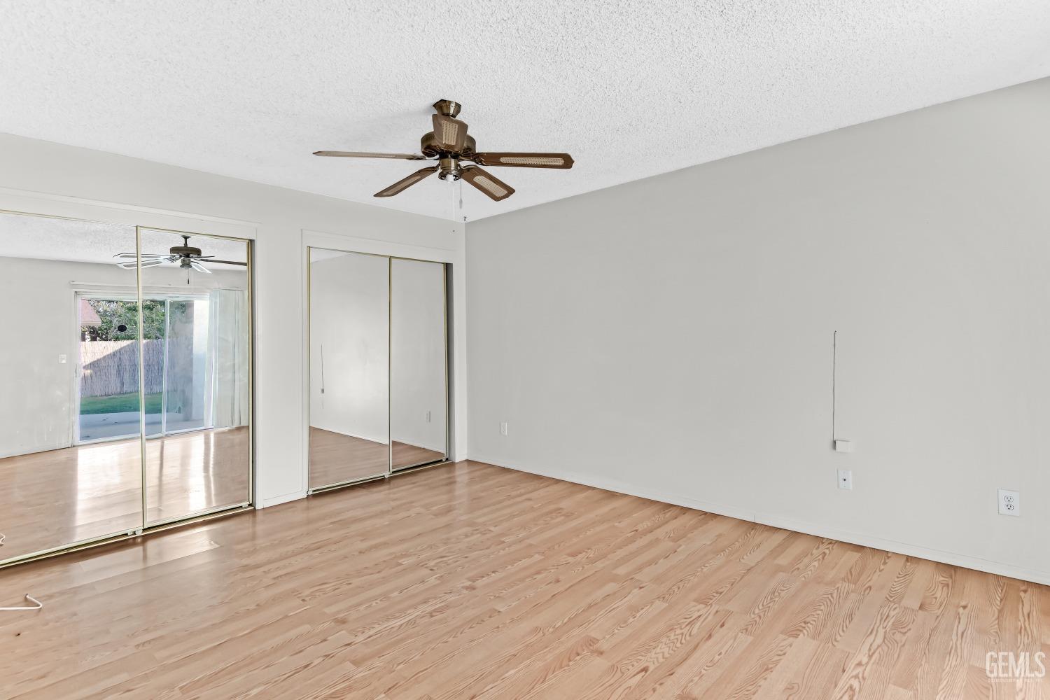 Undisclosed Address Bakersfield, CA 93313 - Photo 22 of 33 wooden floor in an empty room with a window