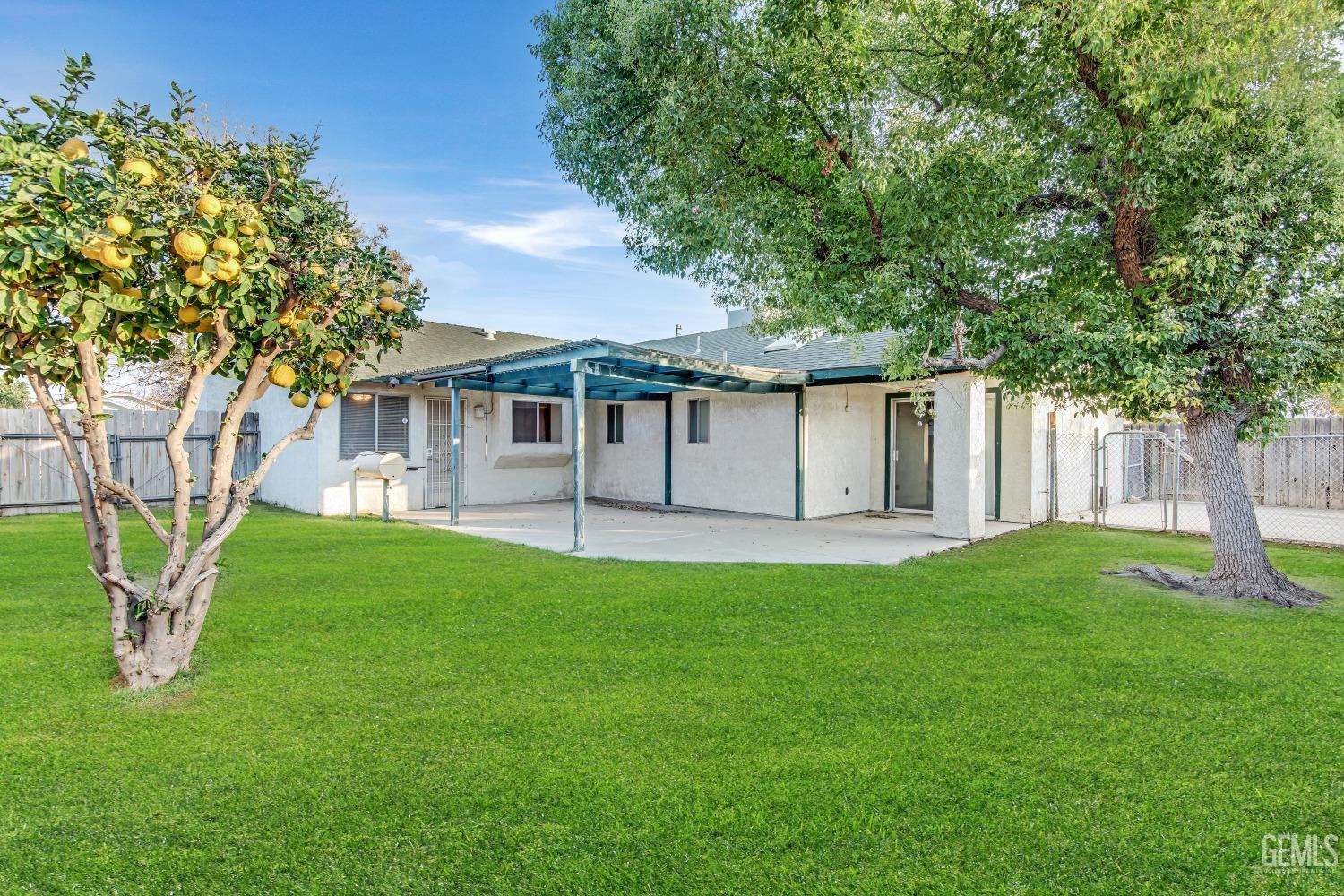 Undisclosed Address Bakersfield, CA 93313 - Photo 28 of 33 a front view of a house with a garden