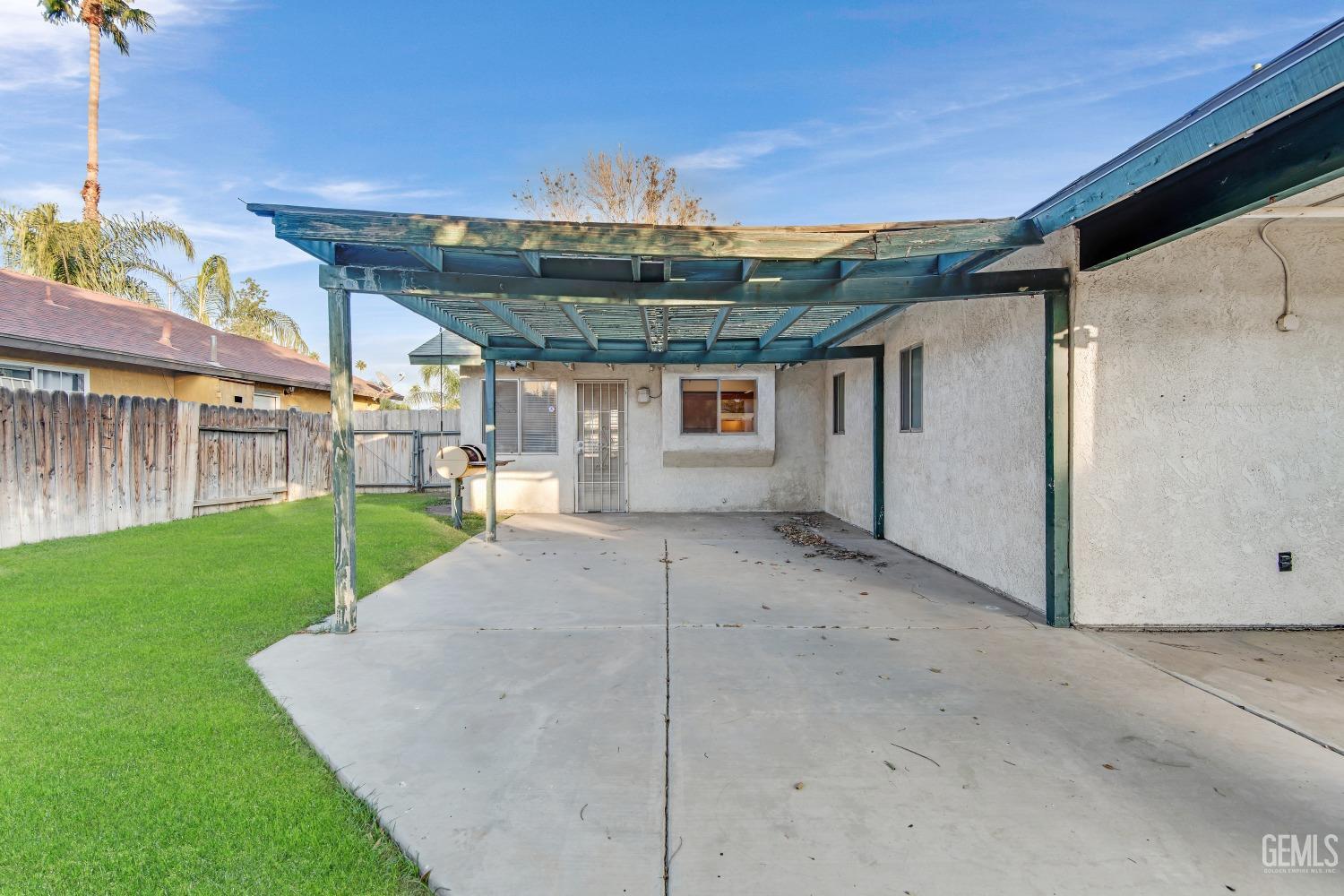 Undisclosed Address Bakersfield, CA 93313 - Photo 31 of 33 a view of a house with a backyard and plants