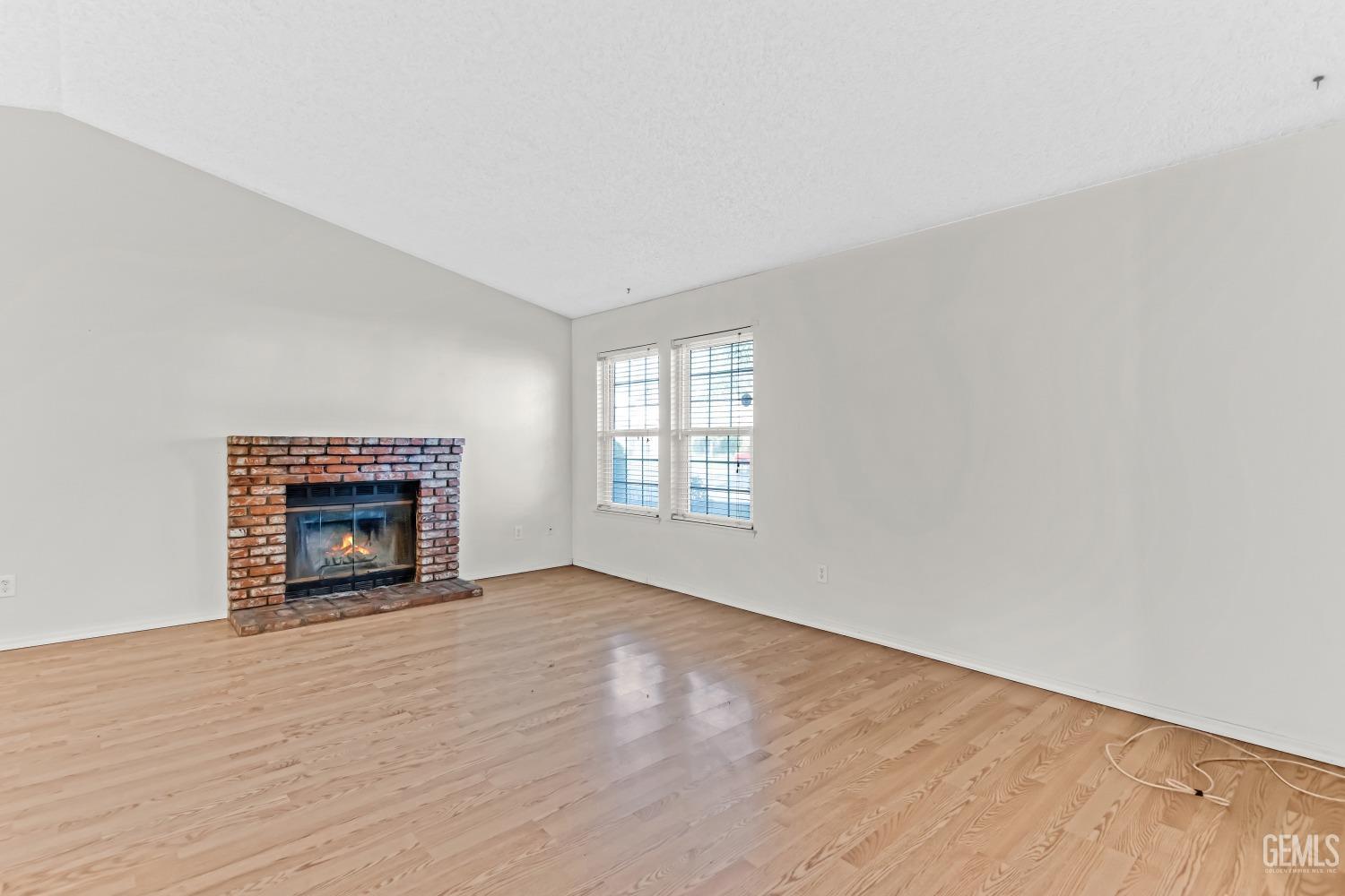 Undisclosed Address Bakersfield, CA 93313 - Photo 5 of 33 a view of an empty room with a window and fireplace