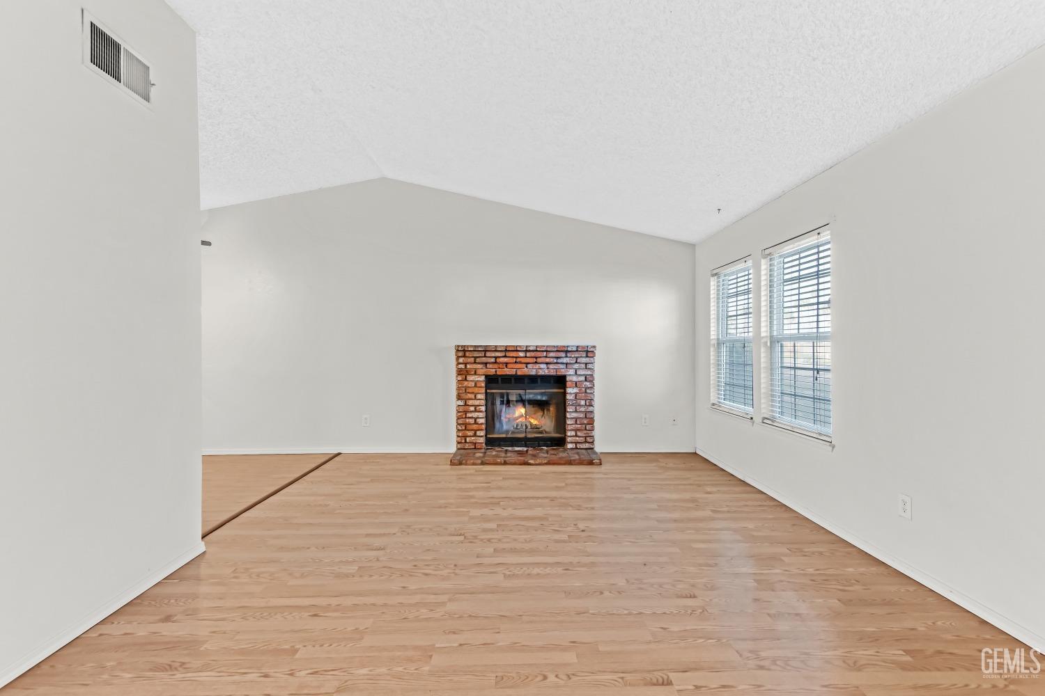Undisclosed Address Bakersfield, CA 93313 - Photo 6 of 33 a view of an empty room with a window and fireplace