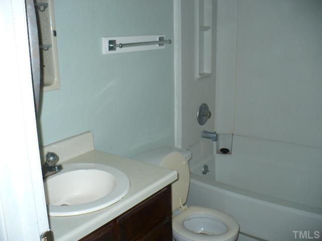 7723 Ohmann Court Raleigh, NC 27615 - Photo 12 of 16 a bathroom with a sink toilet and shower