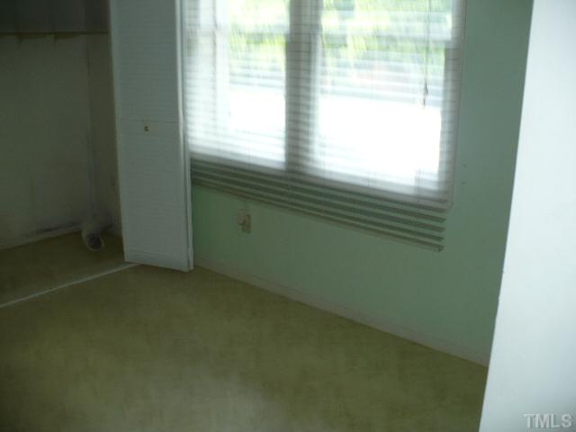 7723 Ohmann Court Raleigh, NC 27615 - Photo 4 of 16 a view of an empty room and window