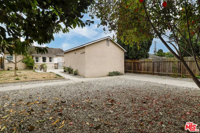 a view of a backyard with a large tree