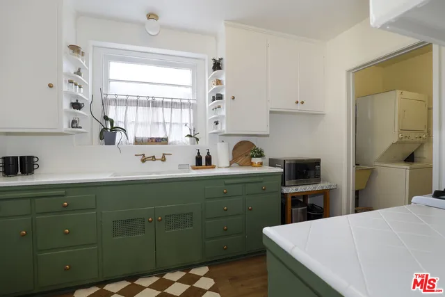 a kitchen with a sink a stove and refrigerator