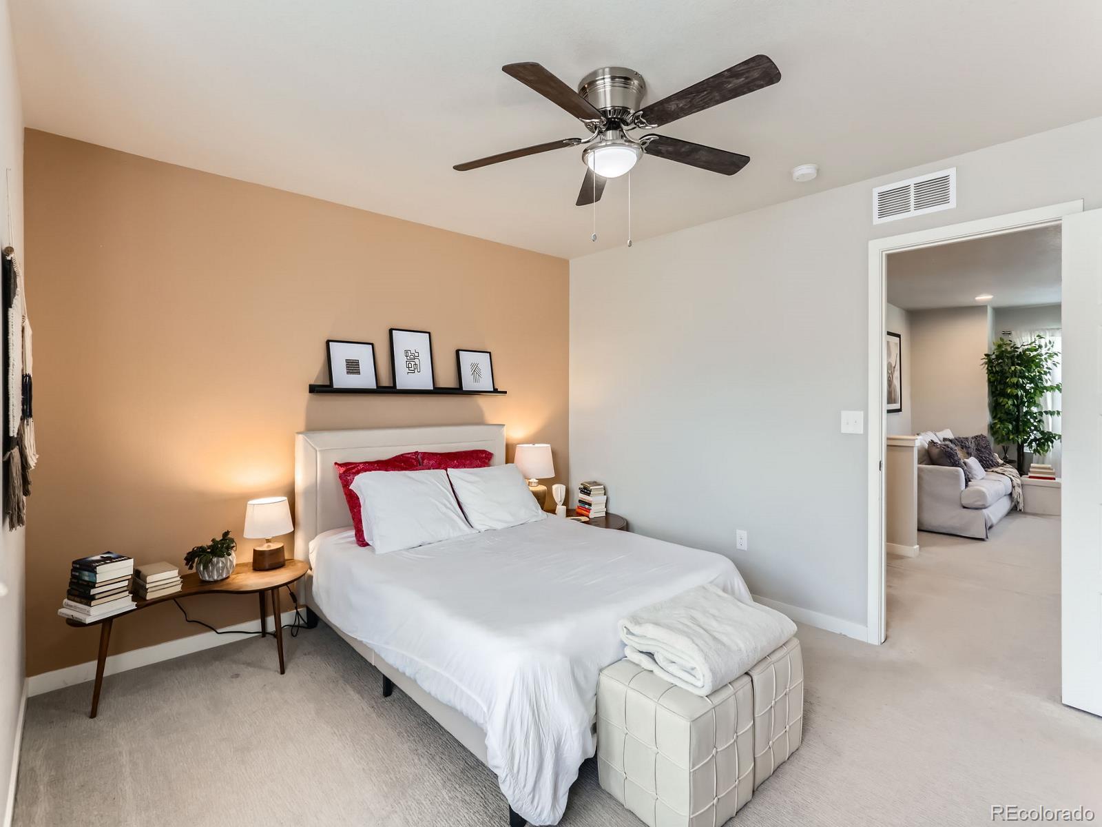 2899 Merry Rest Way Castle Rock, CO 80109 - Photo 15 of 39 a bedroom with a bed and a chandelier