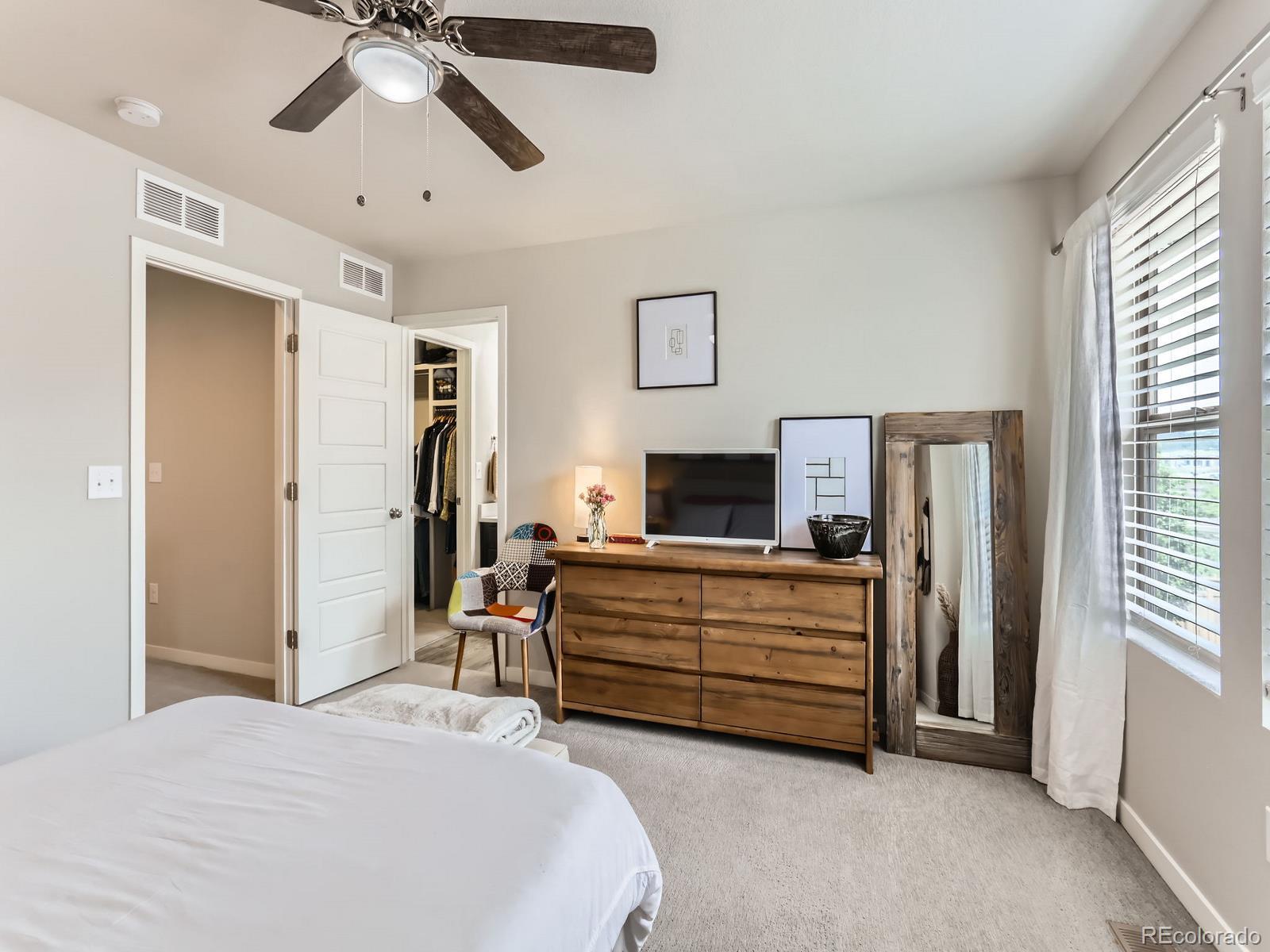 2899 Merry Rest Way Castle Rock, CO 80109 - Photo 16 of 39 a bedroom with furniture and a flat screen tv