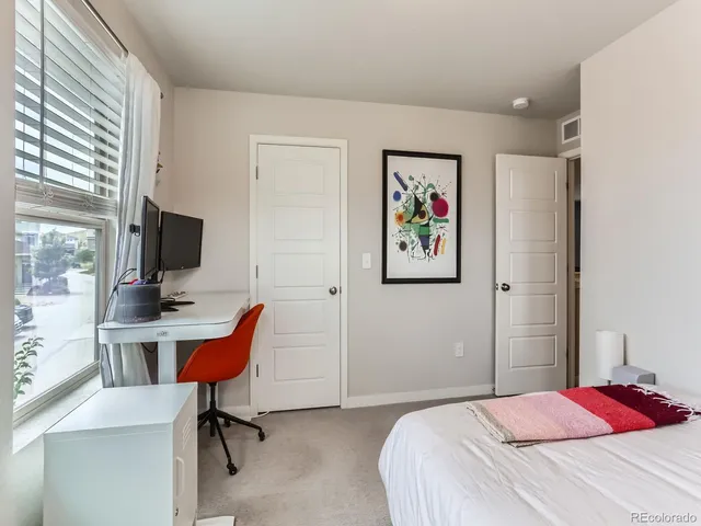 a bedroom with a workspace