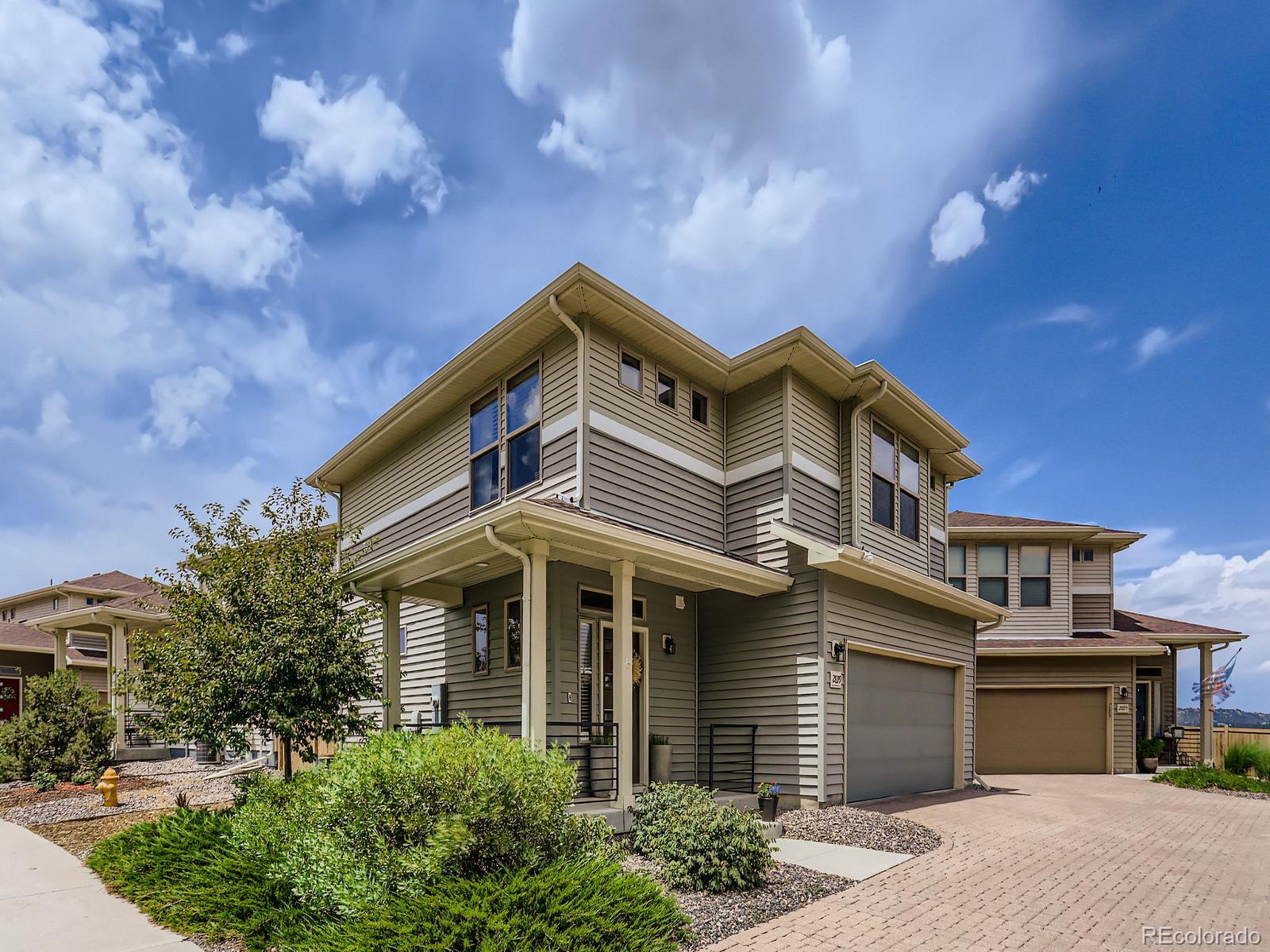 2899 Merry Rest Way Castle Rock, CO 80109 - Photo 2 of 39 a front view of a house with a garden