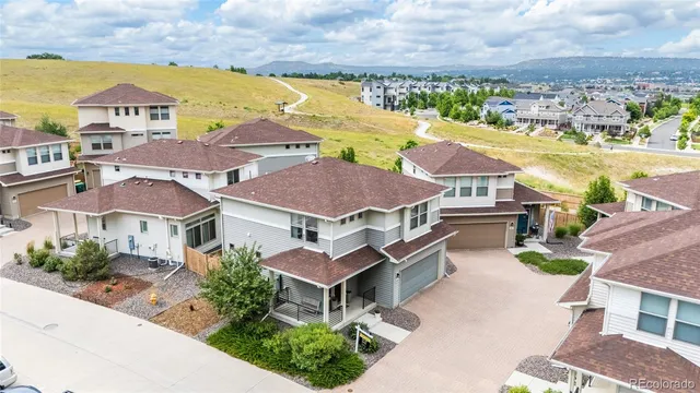 a aerial view of residential houses with outdoor space and ocean view