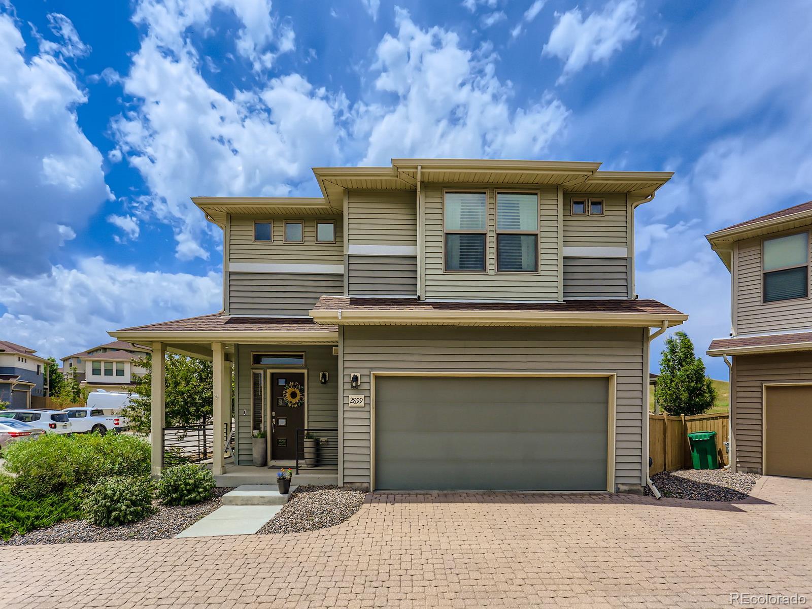 2899 Merry Rest Way Castle Rock, CO 80109 - Photo 4 of 39 a front view of a house with a garden