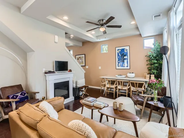 a living room with furniture a fireplace and a flat screen tv