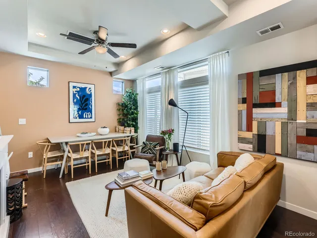 a living room with furniture wooden floor and a window