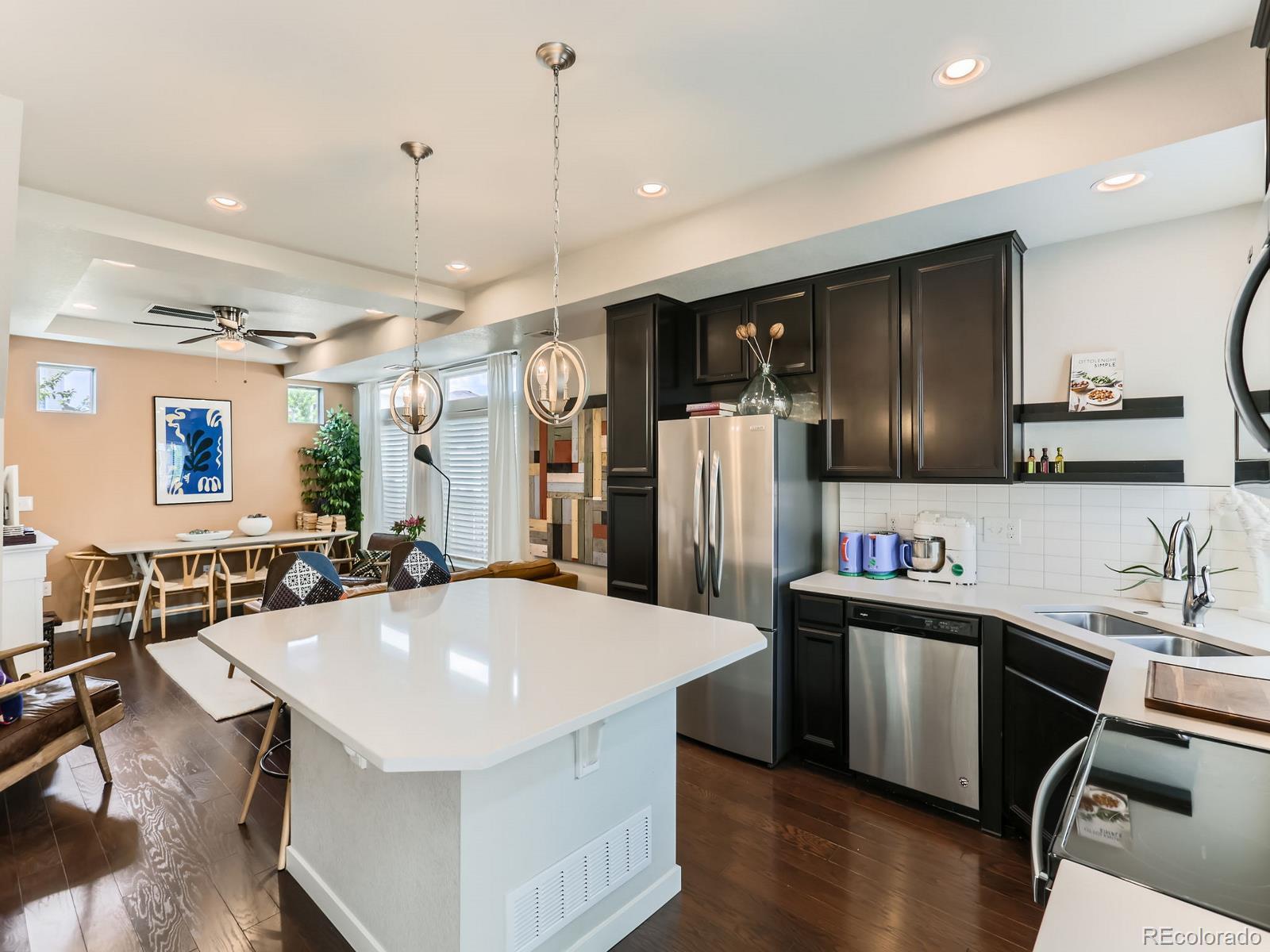 2899 Merry Rest Way Castle Rock, CO 80109 - Photo 10 of 39 a kitchen with stainless steel appliances a sink a counter top space cabinets and wooden floor