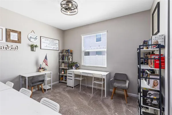a room with furniture a desk and a book shelf