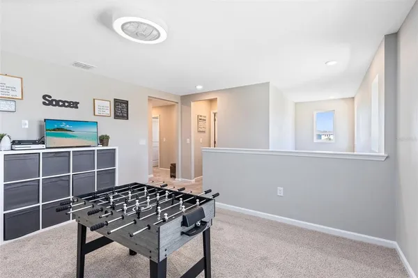 a living room with a bed and a window