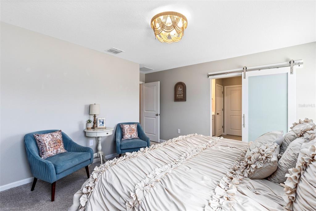4160 Southern Vista Loop St. Cloud, FL 34772 - Photo 17 of 36 a bedroom with a bed and a chair