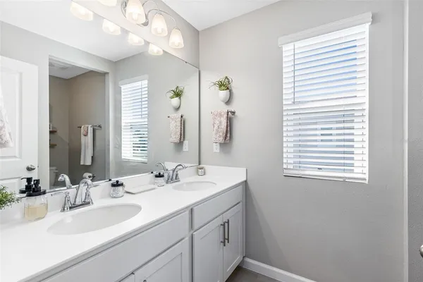 a bathroom with a sink a vanity and a mirror