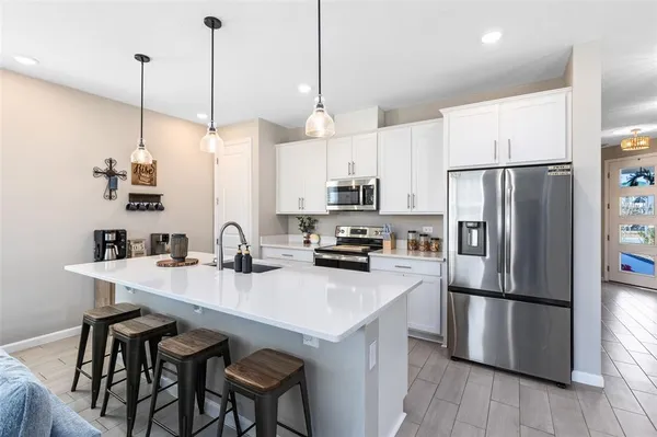 a kitchen with refrigerator cabinets and wooden floor