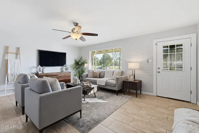 a living room with furniture and a flat screen tv