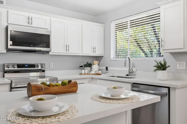 a kitchen with a sink and a stove top oven