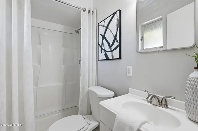 a bathroom with a toilet sink and shower