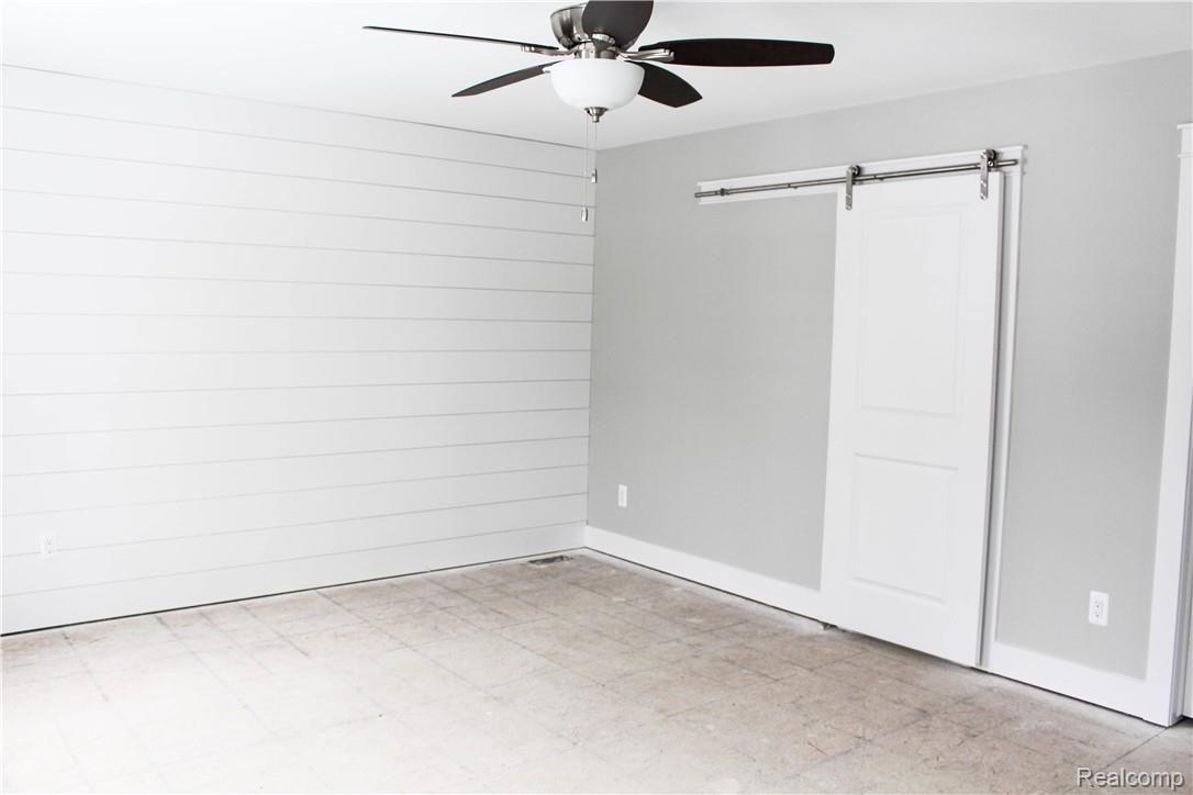 98 North Baldwin Road Oxford, MI 48371 - Photo 23 of 33 Master Bedroom shiplap wall and barn door to the bathroom