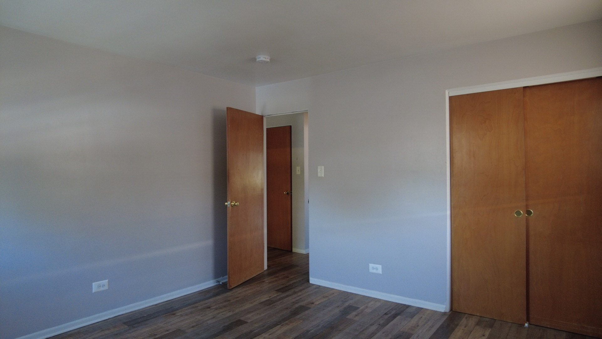 9215 South Pulaski Road, Unit 3N Evergreen Park, IL 60805 - Photo 2 of 8 an empty room with wooden floor and closet