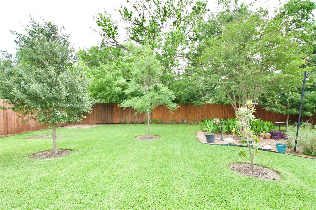 1307 North 65th Street Waco, TX 76710 - Photo 27 of 35 a view of a backyard with plants and a slide