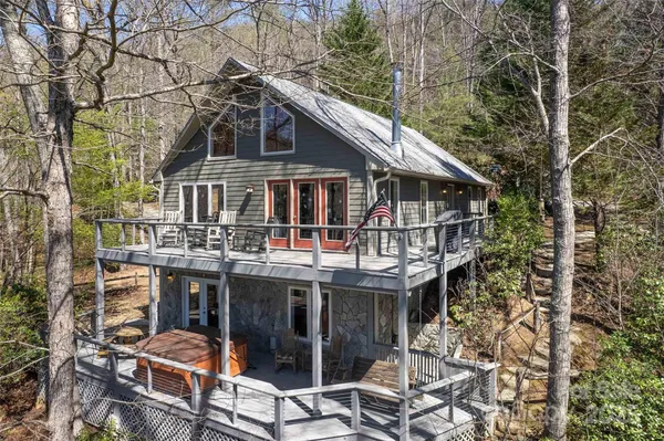 a view of a house with roof deck and next to a yard