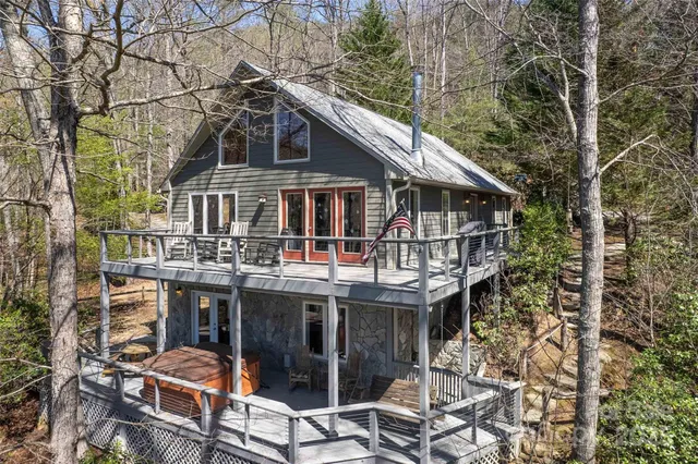 a view of a house with roof deck and next to a yard