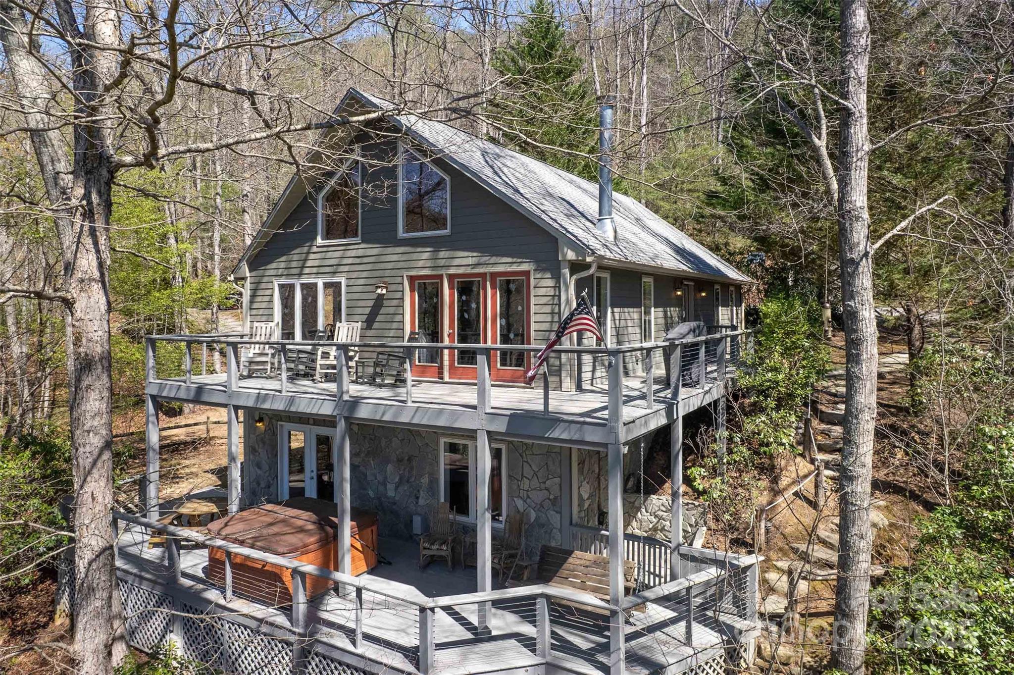 a view of a house with roof deck and next to a yard