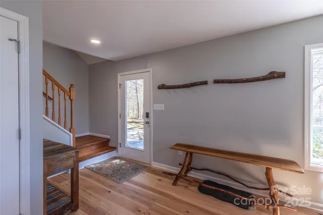 a living room with furniture kitchen view and a large window