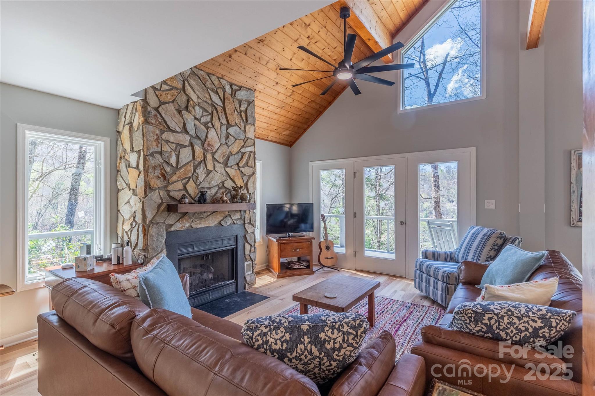 136 Dars Lane Tuckasegee, NC 28783 - Photo 18 of 39 a living room with furniture large window and a fireplace