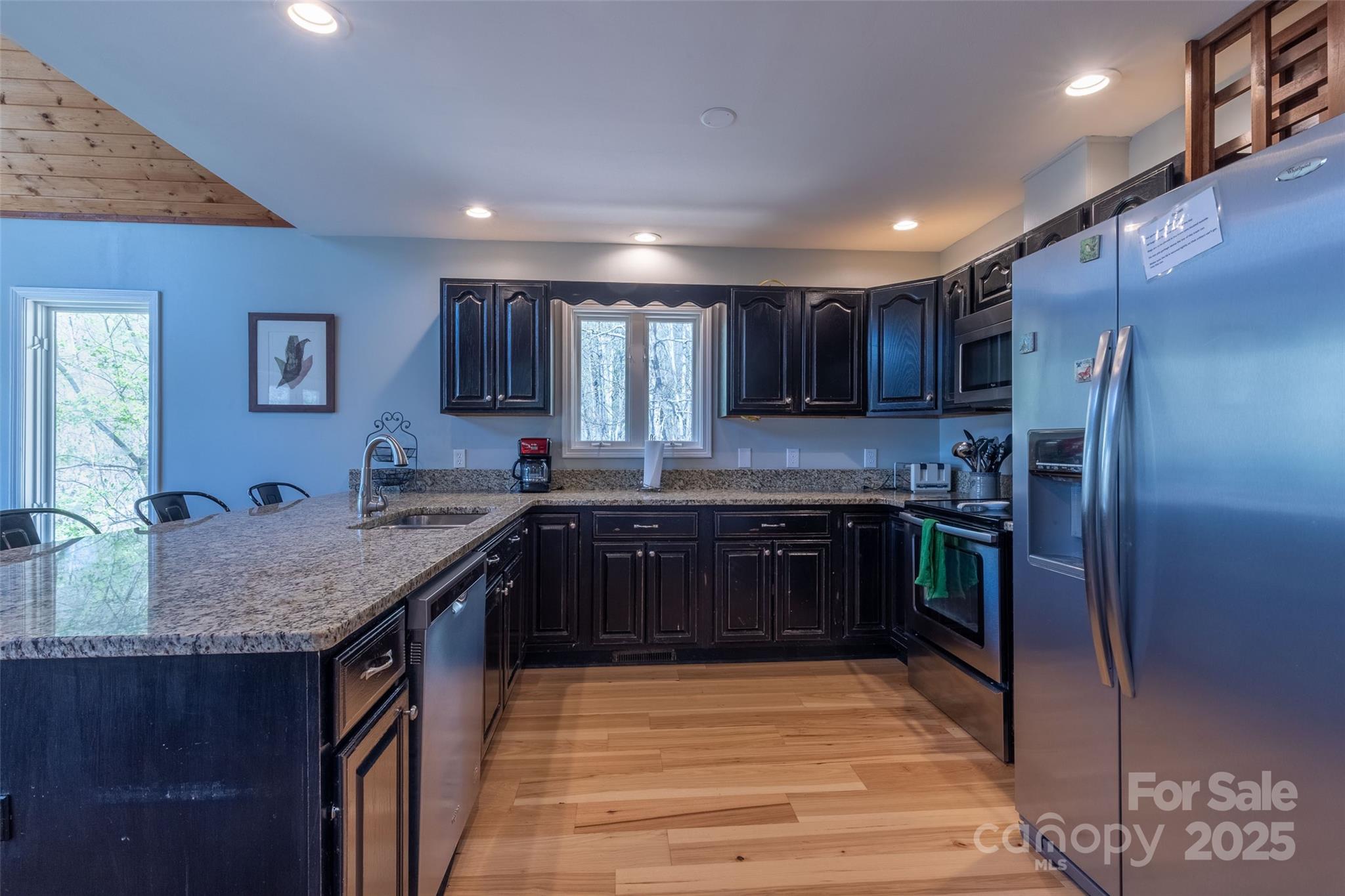 136 Dars Lane Tuckasegee, NC 28783 - Photo 24 of 39 a kitchen with stainless steel appliances granite countertop a sink stove and refrigerator
