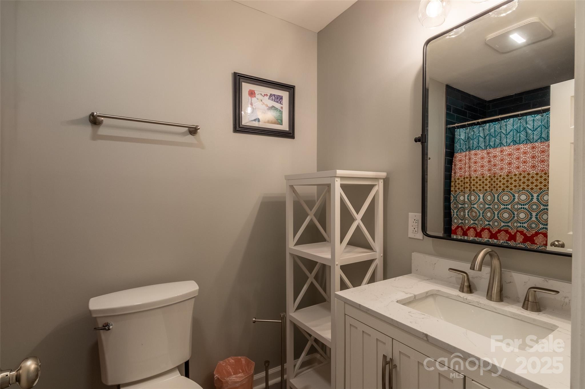 136 Dars Lane Tuckasegee, NC 28783 - Photo 30 of 39 a bathroom with a sink a toilet and a mirror