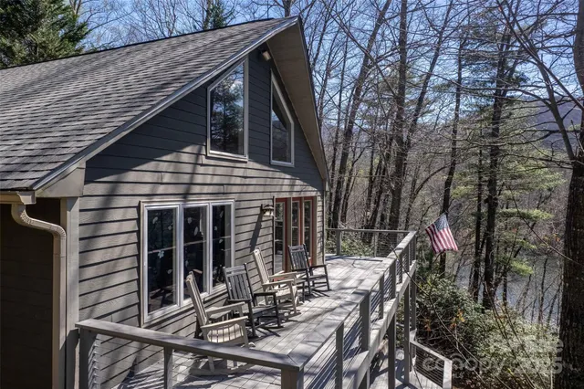 a view of backyard with deck and outdoor seating