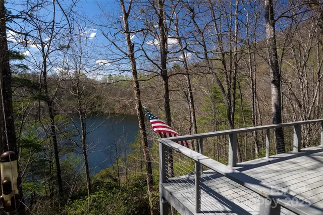 a view of balcony with wooden floor and fence