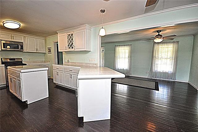 330 Shorter Road Lebanon, TN 37090 - Photo 12 of 20 a kitchen with stainless steel appliances a white stove top oven a sink dishwasher and white cabinets with wooden floor