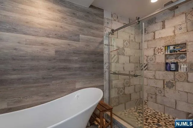 a bathroom with a bathtub and shower