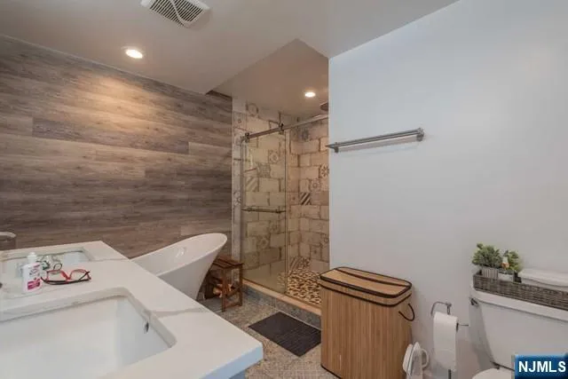 a bathroom with a sink a toilet and shower