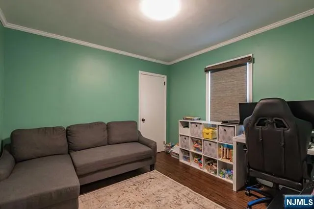 a living room with furniture and a book shelf