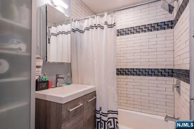 a bathroom with a sink a mirror and a shower
