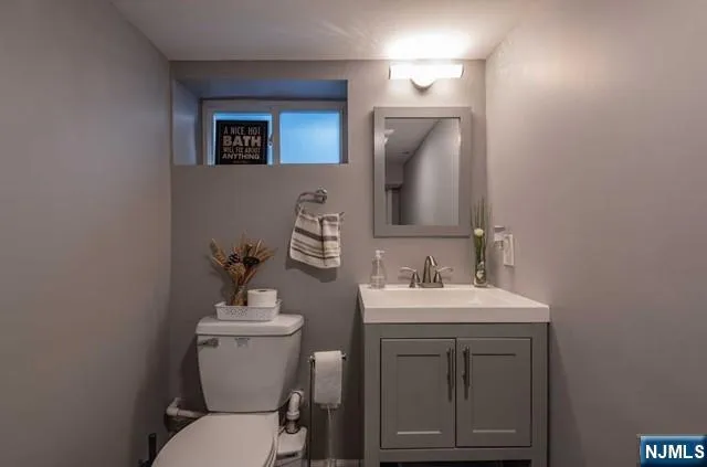 a bathroom with a toilet sink and mirror