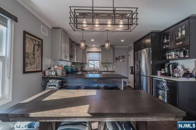 a kitchen with stainless steel appliances granite countertop a stove a refrigerator a sink and a counter